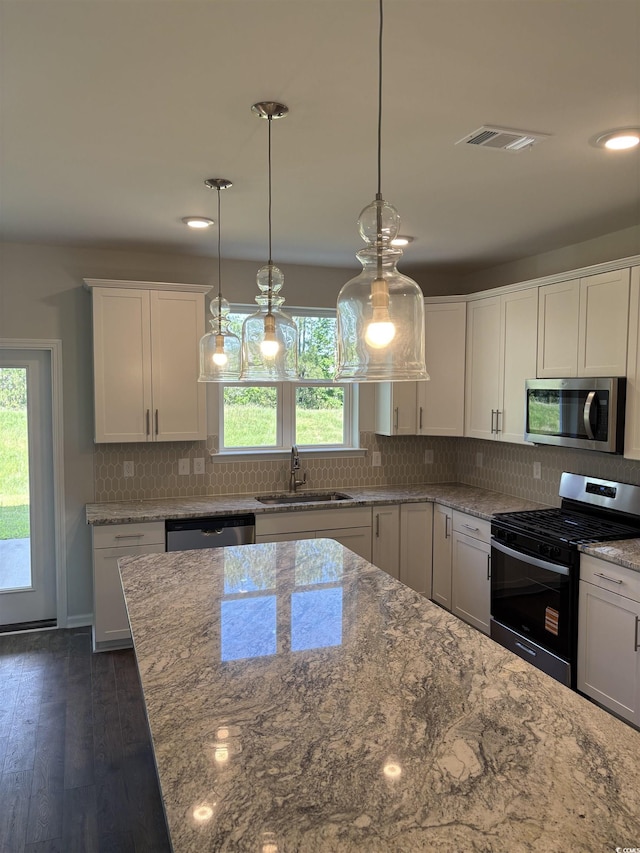 5504 Shelly Lynn Dr, Myrtle Beach, SC 29579 - kitchen with pendant lighting, white cabinetry, light stone counters, a sink, and stainless steel appliances