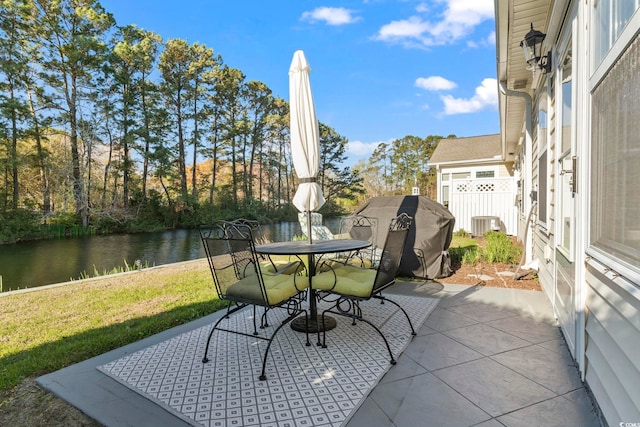 view of patio / terrace with outdoor dining space and a water view