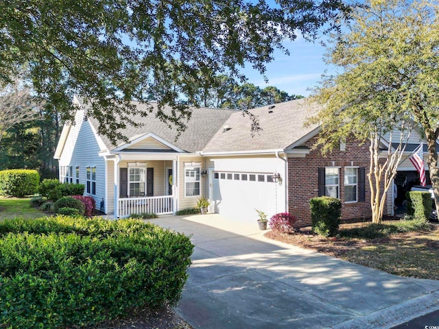 ranch-style home featuring driveway, a shingled roof, covered porch, brick siding, and a garage