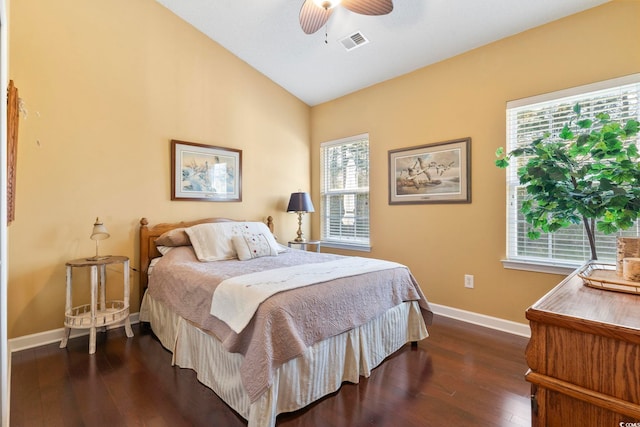 bedroom featuring wood-type flooring, a ceiling fan, visible vents, baseboards, and lofted ceiling
