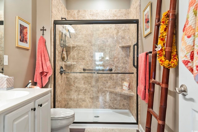 full bath featuring toilet, a shower stall, and vanity