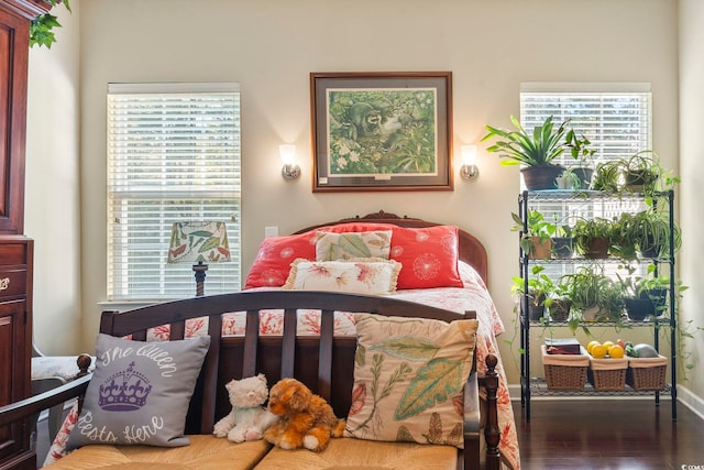 bedroom featuring wood finished floors and baseboards