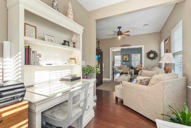 living area with visible vents, a ceiling fan, dark wood-type flooring, and plenty of natural light