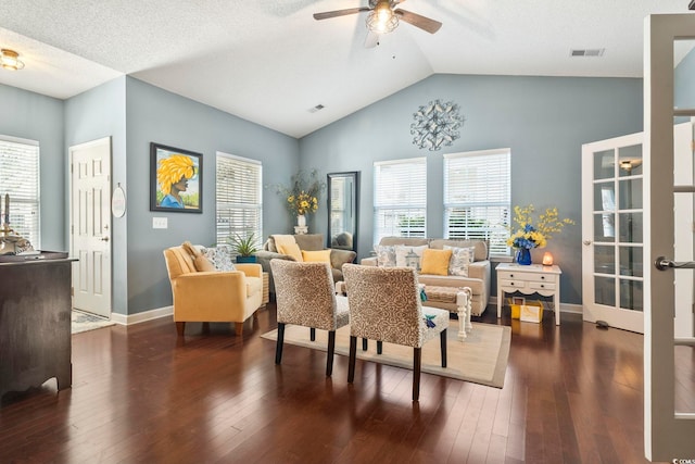 living area with visible vents, ceiling fan, hardwood / wood-style flooring, and baseboards