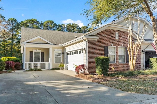 view of front facade with covered porch, concrete driveway, an attached garage, and brick siding