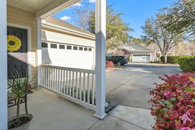 garage featuring concrete driveway