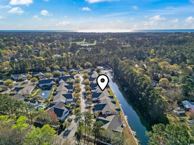 drone / aerial view with a residential view and a water view