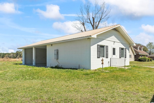 1136 Knotty Branch Rd, Conway, SC 29527 - view of home's exterior featuring a lawn, concrete block siding, metal roof, and a sunroom