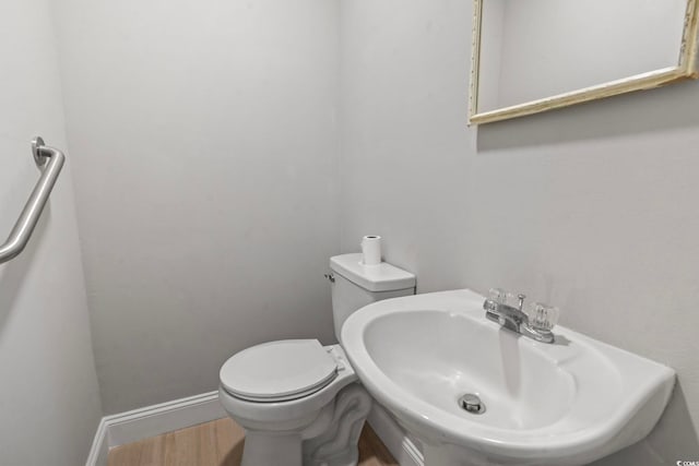 1136 Knotty Branch Rd, Conway, SC 29527 - bathroom featuring wood finished floors, toilet, a sink, and baseboards
