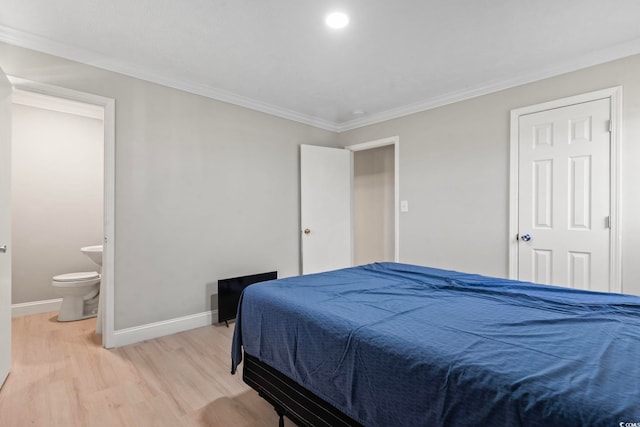 1136 Knotty Branch Rd, Conway, SC 29527 - bedroom with light wood-style floors, baseboards, ornamental molding, and ensuite bath