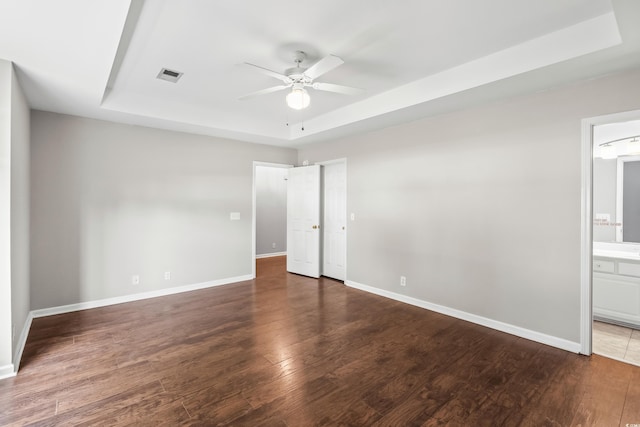 4195 Wrens Xing, Little River, SC 29566 - unfurnished bedroom featuring a tray ceiling, wood finished floors, and baseboards