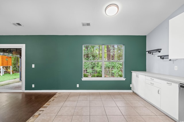 4195 Wrens Xing, Little River, SC 29566 - kitchen featuring white cabinets, light countertops, dishwasher, baseboards, and light tile patterned flooring