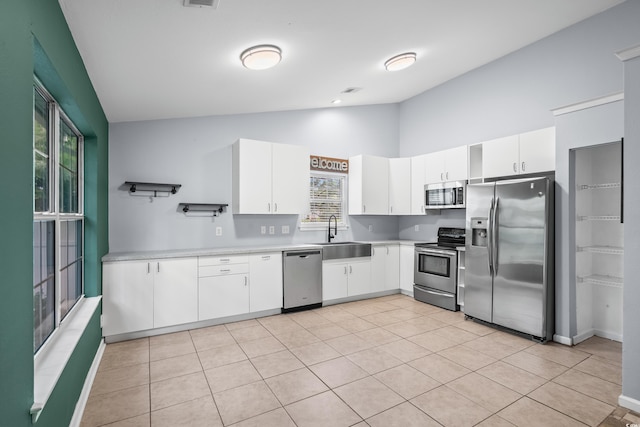 4195 Wrens Xing, Little River, SC 29566 - kitchen featuring appliances with stainless steel finishes, a sink, light countertops, white cabinets, and high vaulted ceiling
