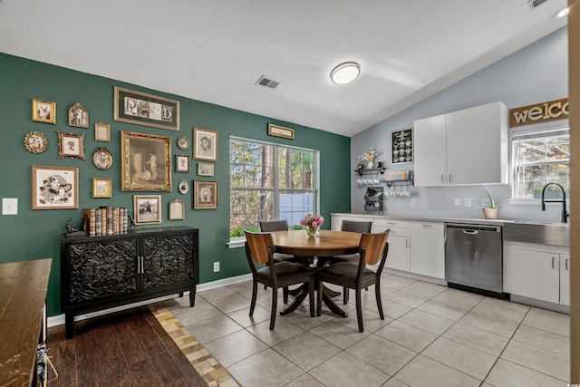 4195 Wrens Xing, Little River, SC 29566 - dining space with lofted ceiling, healthy amount of natural light, baseboards, and light tile patterned flooring