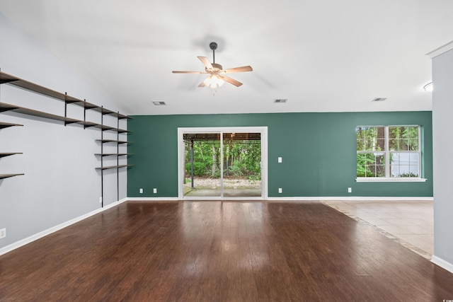 4195 Wrens Xing, Little River, SC 29566 - unfurnished living room with ceiling fan, healthy amount of natural light, wood finished floors, and baseboards