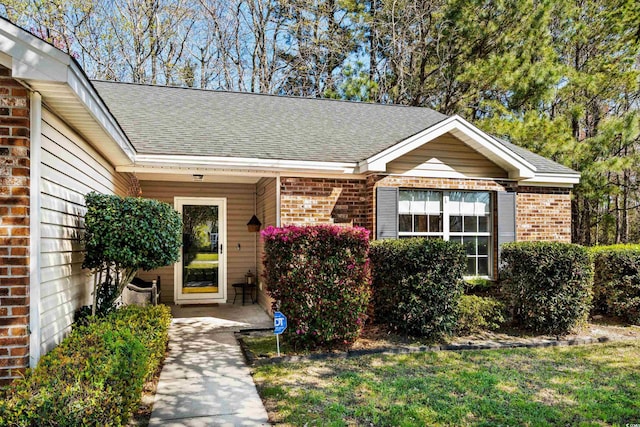 4195 Wrens Xing, Little River, SC 29566 - doorway to property featuring brick siding and roof with shingles