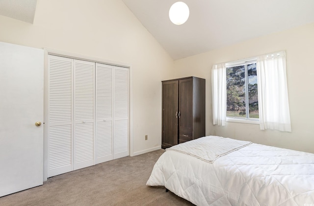 carpeted bedroom featuring high vaulted ceiling and a closet