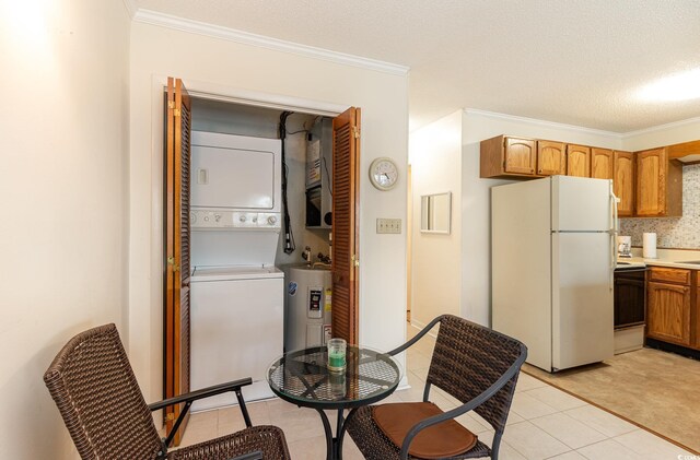 kitchen with electric stove, electric water heater, ornamental molding, and freestanding refrigerator