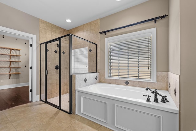 full bath featuring recessed lighting, a garden tub, and a stall shower