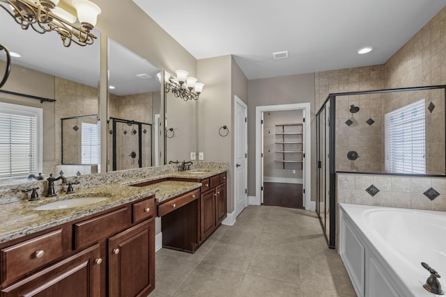 bathroom featuring a sink, a shower stall, and a healthy amount of sunlight