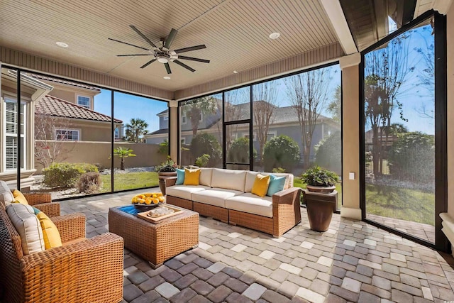 sunroom / solarium with an outdoor hangout area, a wealth of natural light, and ceiling fan
