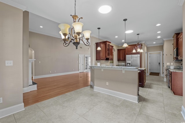 kitchen with ornamental molding, a peninsula, a kitchen bar, appliances with stainless steel finishes, and a notable chandelier