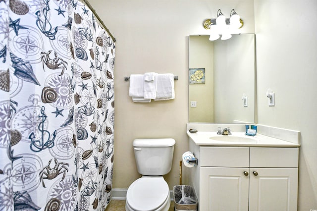bathroom with toilet, vanity, baseboards, and curtained shower