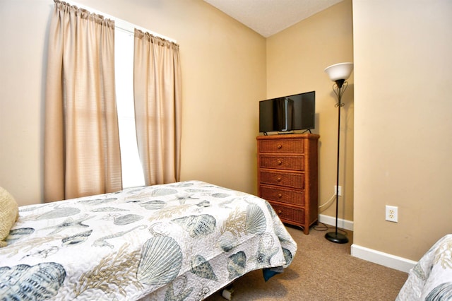 carpeted bedroom with baseboards