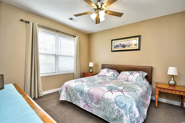 carpeted bedroom with baseboards, ceiling fan, and a textured ceiling