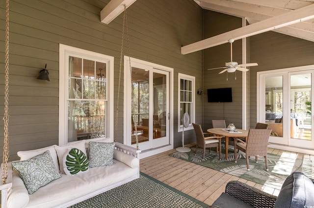 sunroom with outdoor dining space, beamed ceiling, french doors, and a ceiling fan