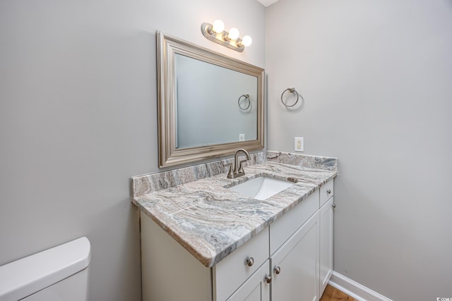 half bath with toilet and vanity