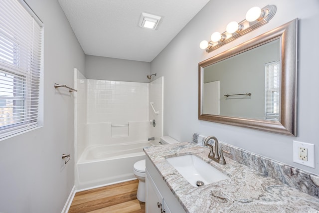 full bath featuring vanity, toilet, wood finished floors, and a wealth of natural light