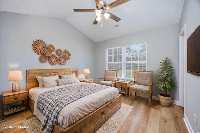 bedroom with a ceiling fan, visible vents, vaulted ceiling, baseboards, and light wood finished floors