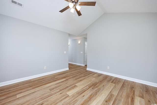 unfurnished room with visible vents, baseboards, ceiling fan, high vaulted ceiling, and light wood-style flooring
