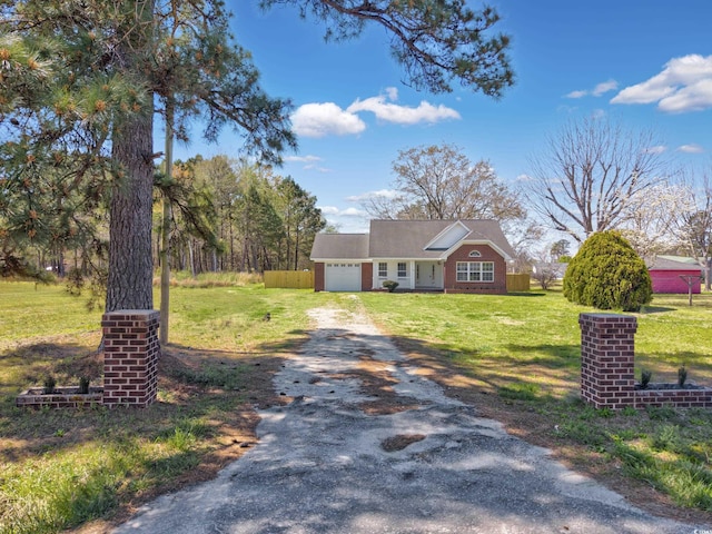 view of front of house with a garage, a front lawn, and aphalt driveway