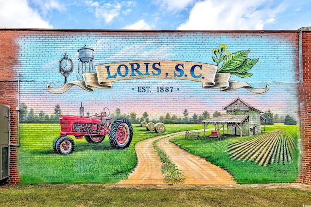 community sign featuring a lawn