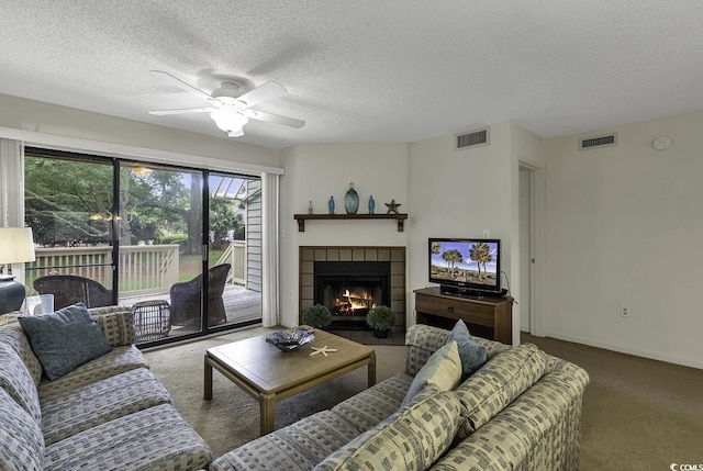 118 Hartland Dr Unit 12-C, Myrtle Beach, SC 29572 - carpeted living room with a ceiling fan, a tiled fireplace, and a textured ceiling