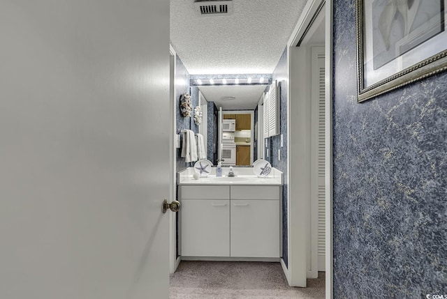 118 Hartland Dr Unit 12-C, Myrtle Beach, SC 29572 - bathroom with vanity, a closet, and a textured ceiling
