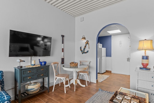6803 N Ocean Blvd Unit 203, Myrtle Beach, SC 29572 - dining area with arched walkways, lofted ceiling, and wood finished floors