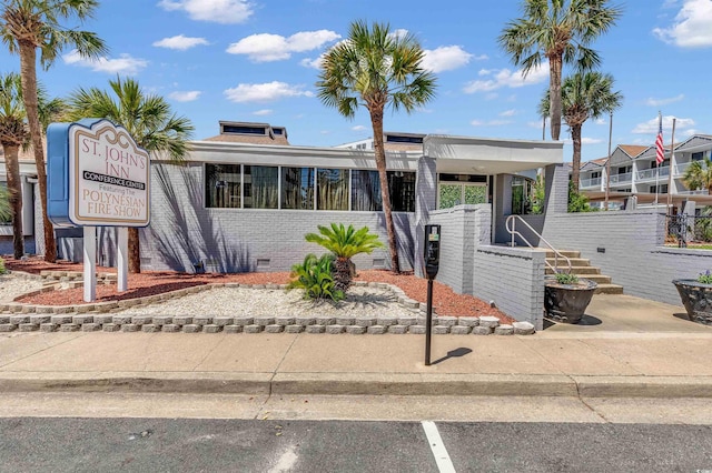 6803 N Ocean Blvd Unit 203, Myrtle Beach, SC 29572 - view of front of property with brick siding, crawl space, and stairs
