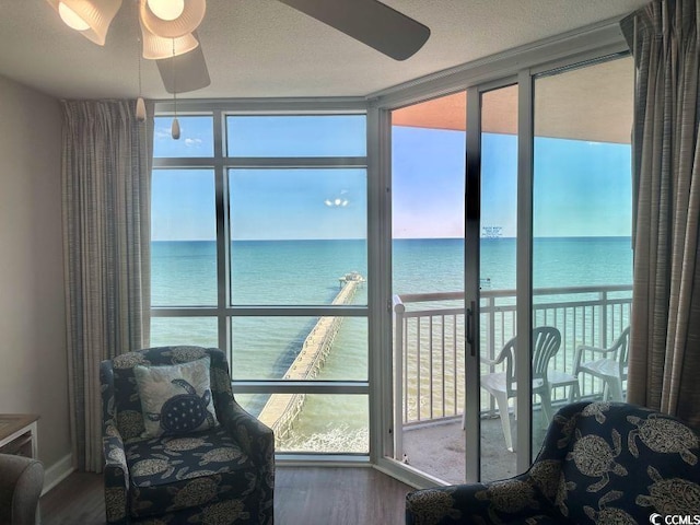 3500 N Ocean Blvd Unit 1203, North Myrtle Beach, SC 29582 - sunroom / solarium featuring a water view, wood finished floors, and a wall of windows