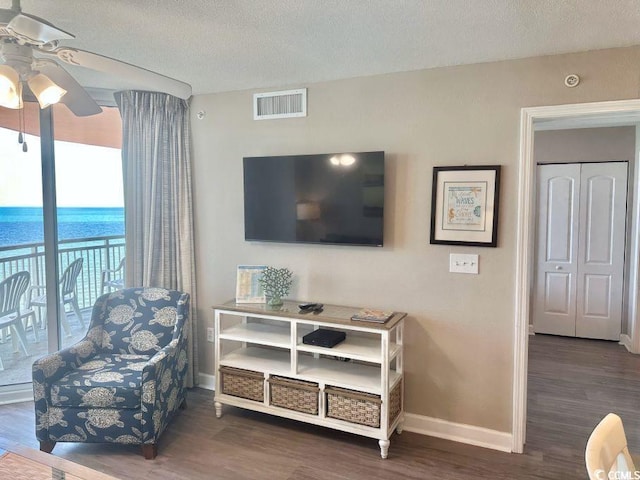 3500 N Ocean Blvd Unit 1203, North Myrtle Beach, SC 29582 - living area featuring a ceiling fan, wood finished floors, and a textured ceiling