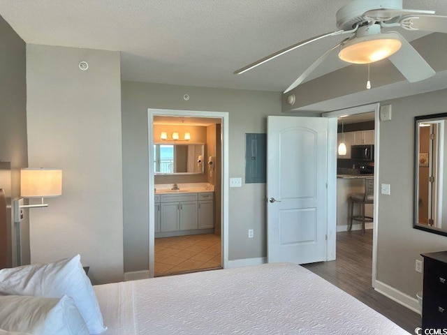 3500 N Ocean Blvd Unit 1203, North Myrtle Beach, SC 29582 - bedroom with ensuite bathroom, electric panel, and wood finished floors