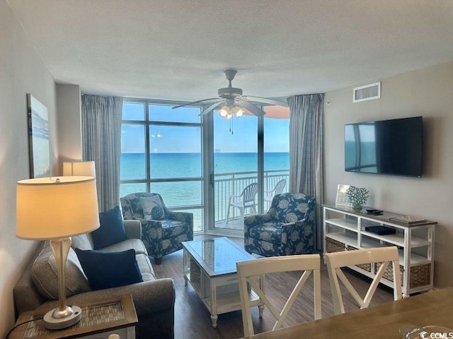 3500 N Ocean Blvd Unit 1203, North Myrtle Beach, SC 29582 - living room featuring a wall of windows, wood finished floors, ceiling fan, and a textured ceiling