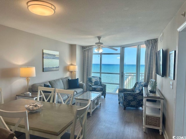 3500 N Ocean Blvd Unit 1203, North Myrtle Beach, SC 29582 - dining area with a textured ceiling, dark wood-style flooring, a ceiling fan, a water view, and a wall of windows