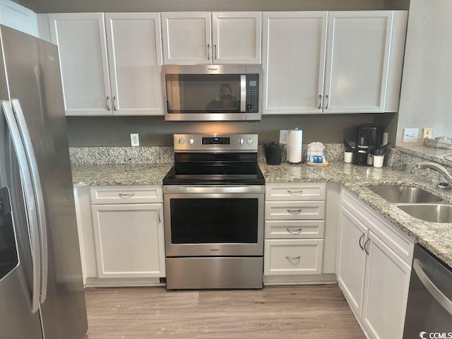 3500 N Ocean Blvd Unit 1203, North Myrtle Beach, SC 29582 - kitchen featuring appliances with stainless steel finishes, white cabinets, and light wood-style floors