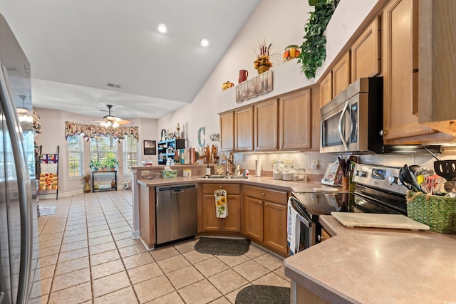 542 Sand Ridge Rd, Conway, SC 29526 - kitchen featuring stainless steel appliances, a sink, a peninsula, backsplash, and light countertops