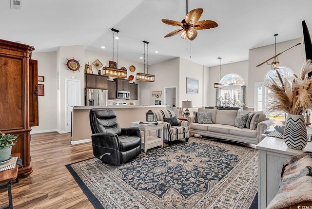 508 Loblolly Ln, Loris, SC 29569 - living area featuring light wood-style flooring, ceiling fan, baseboards, high vaulted ceiling, and a chandelier