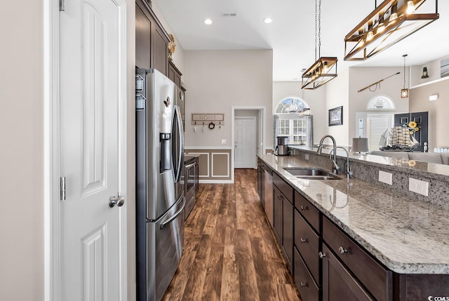 508 Loblolly Ln, Loris, SC 29569 - kitchen featuring stainless steel appliances, a sink, dark wood-style floors, dark brown cabinets, and hanging light fixtures
