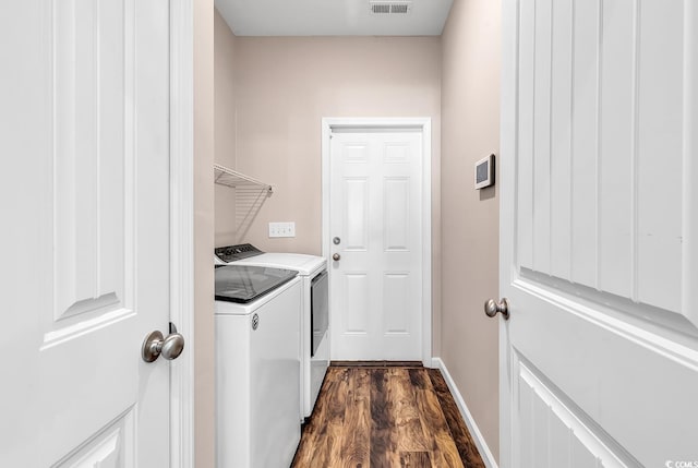 508 Loblolly Ln, Loris, SC 29569 - washroom with washing machine and dryer, baseboards, and dark wood-style flooring